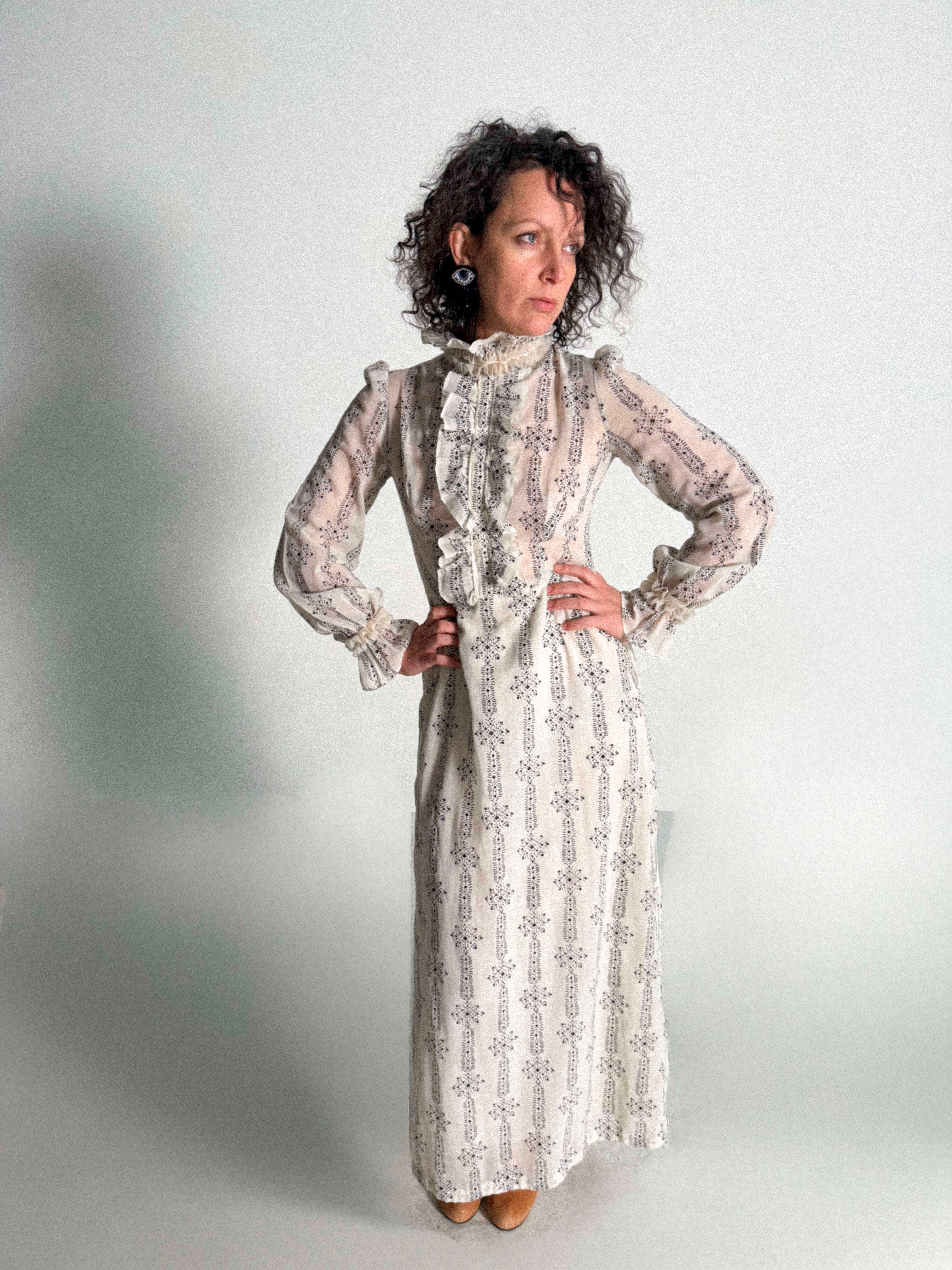 Woman wearing a 1960s Prairie Dress with Ruffles against a plain background