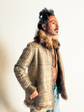 Man wearing a fur-lined jacket with a neutral background