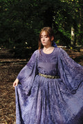 Woman in a 1970s Afghan Plisee Gown  standing in a forest.
