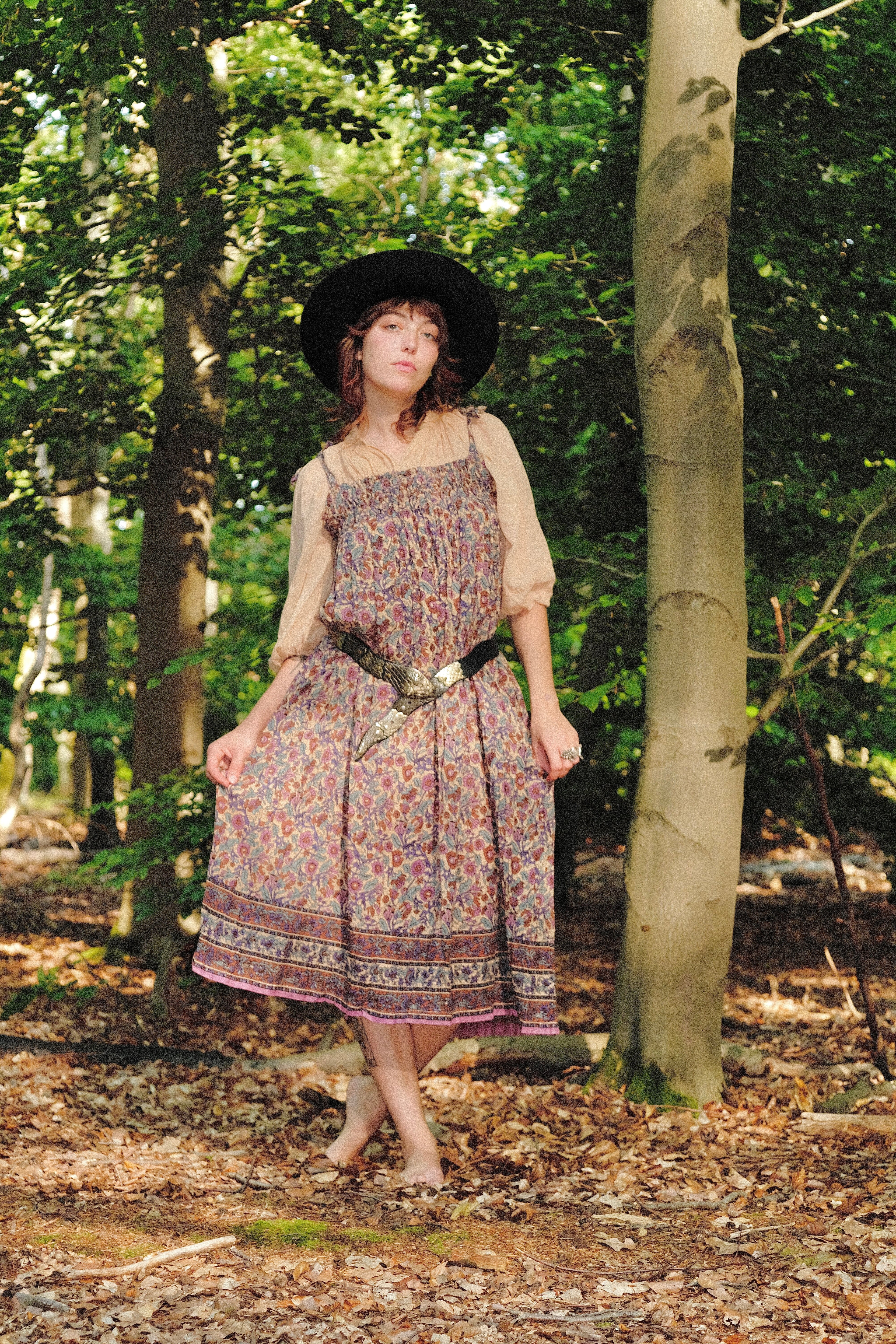 Woman in a 1970s Deadstock Gauze Blouse and Dress Set standing in a forest